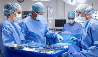 A surgical team gathered around a tray of medical equipment sterilized using nuclear products.