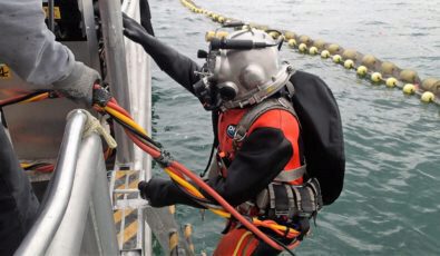 An OPG dive team member exits the water.