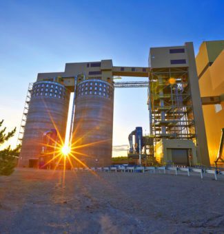 Sunset peeking between the biomass pellet storage silos at Atikokan Generating Station.