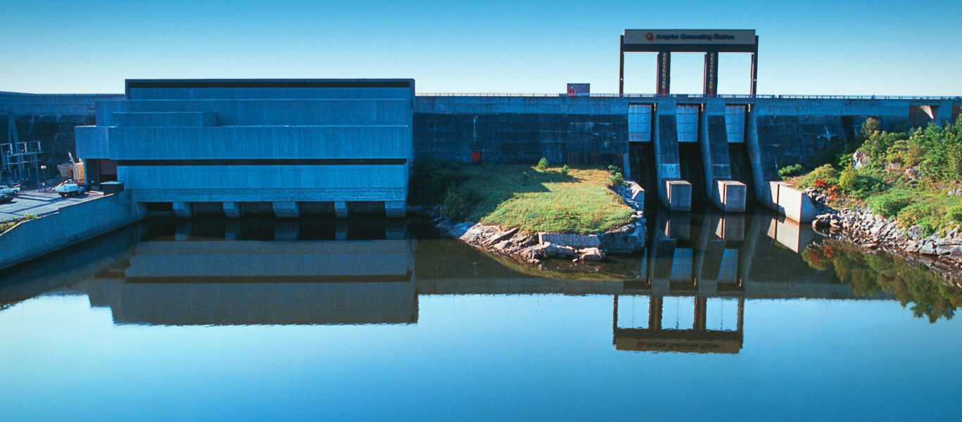 Still waters reflect Arnprior hydroelectric station like a mirror.