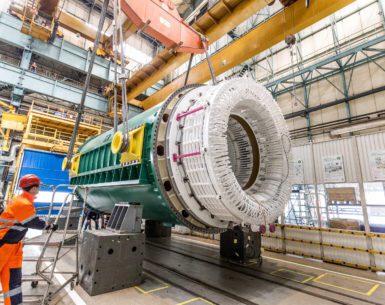 Workers at a GE plant in Poland prepare a massive generator stator for shipment to Darlington Nuclear.