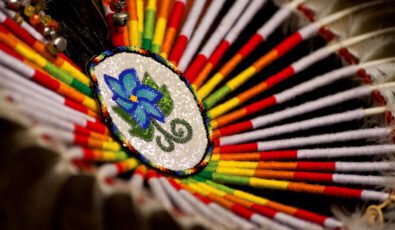 A close-up of a colourful bustle, part of an Indigenous man’s traditional regalia typically worn at a pow wow.