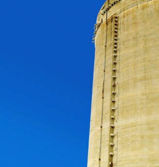 A nuclear tower against a clear blue sky.