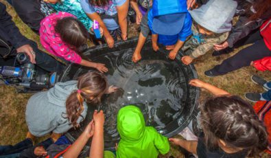 Children of the Dalles First Nation get a close look at a juvenile lake sturgeon.