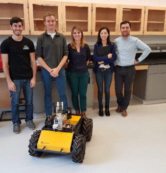 The University of Waterloo team with an autonomous driving robot.