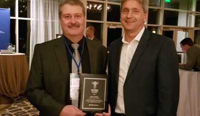 OPG employee Alex Crichton, left, received the Technology Transfer Award from EPRI