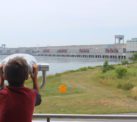 A child looks through a telescopic viewer at Saunders Hydro Generating Station.