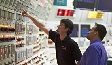 Workers examine controls at OPG's Pickering Nuclear Generating Station.