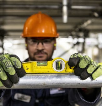 A worker on the Darlington Refurbishment project uses a level