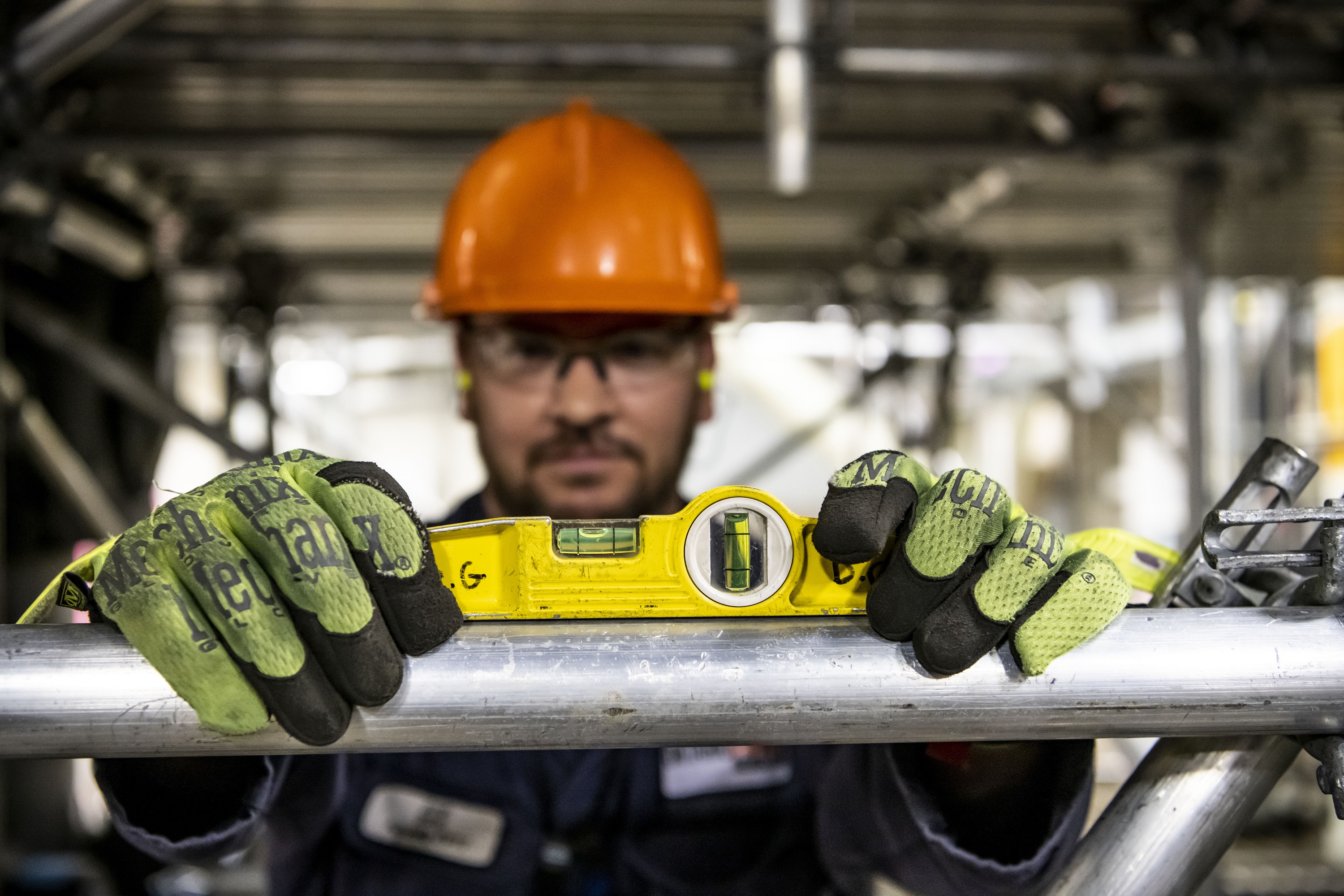A worker on the Darlington Refurbishment project uses a level