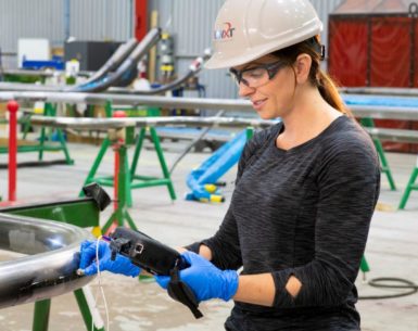 Female BWXT worker with equipment in hand