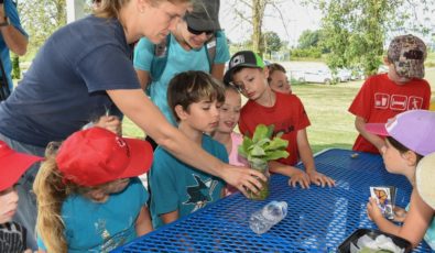 Students get a close-up view of a caterpillar during a Tuesdays on the Trail demonstration in Durham Region.