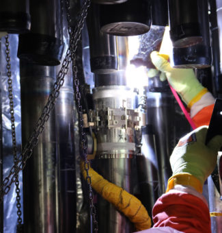 A welder on the Darlington Refurbishment project welds a lower feeder to a middle feeder during the assembly of one of 960 feeder tubes on the Darlington Unit 2 reactor.