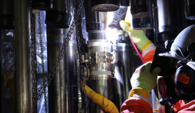 A welder on the Darlington Refurbishment project welds a lower feeder to a middle feeder during the assembly of one of 960 feeder tubes on the Darlington Unit 2 reactor.