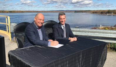 Mike Martelli, OPG's President of Renewable Generation, left, and Simon Racicot-Daigneault, Senior Director, Generation and Maintenance at Hydro-Quebec, sign a new Operating Services Agreement at Chat Falls GS.