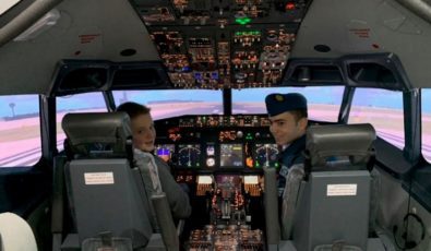 Two local Air Cadets sit in the cockpit of Darlington's flight simulator, which is used to improve human performance behaviours.