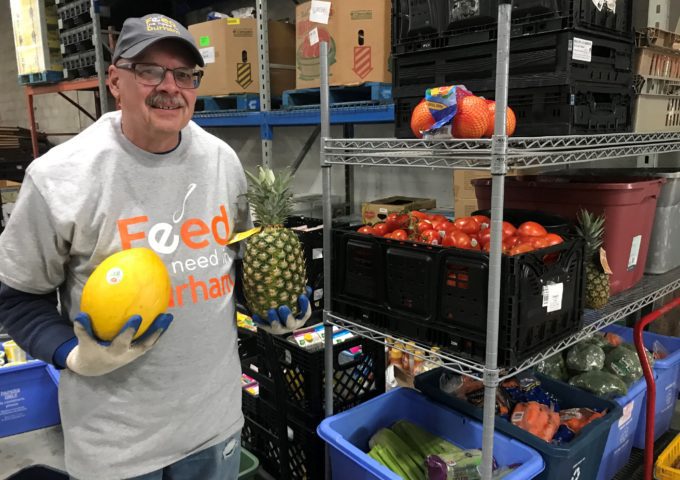 An employee with Feed the Need Durham setting up food deliveries.