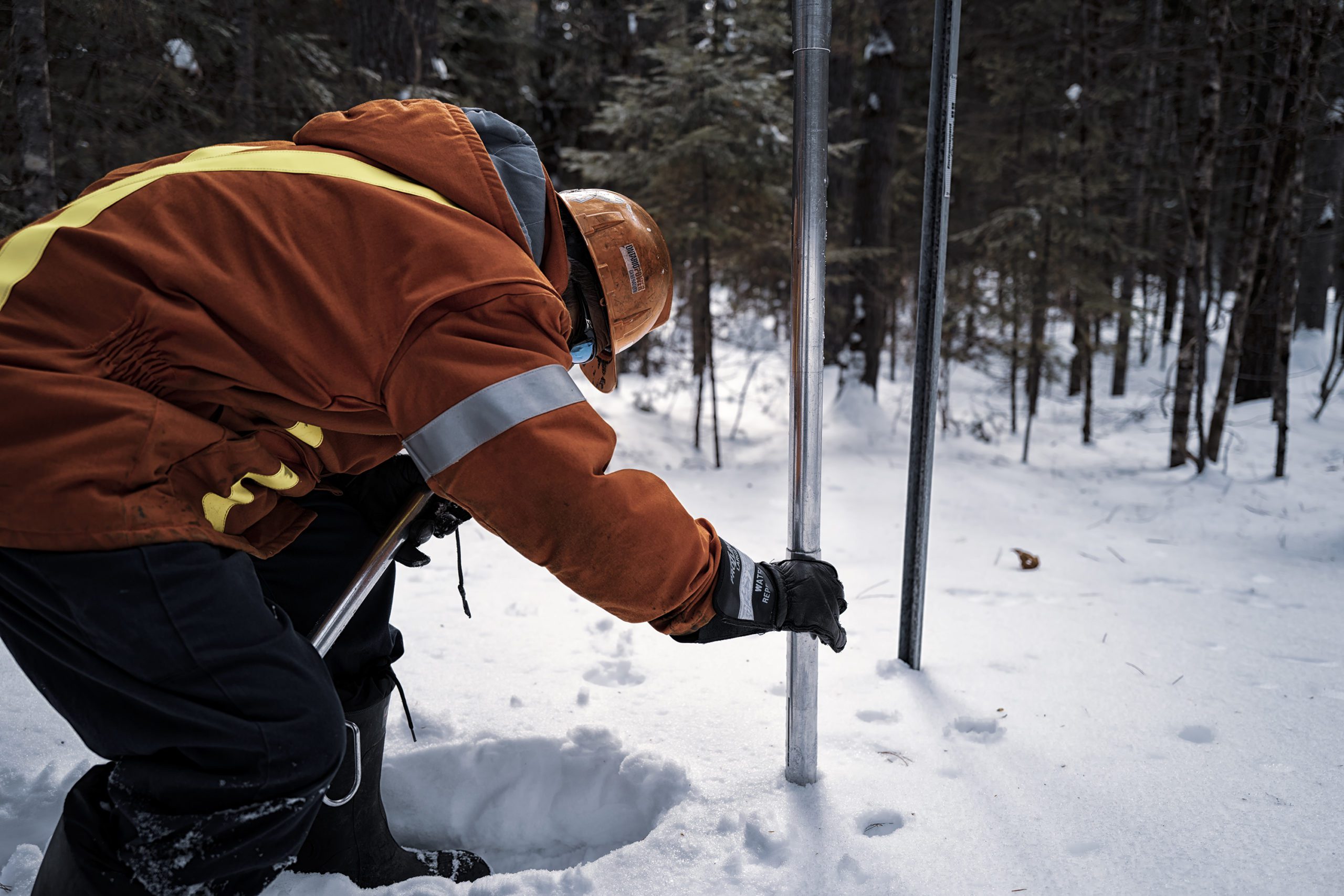 An employee performing a snow survey.
