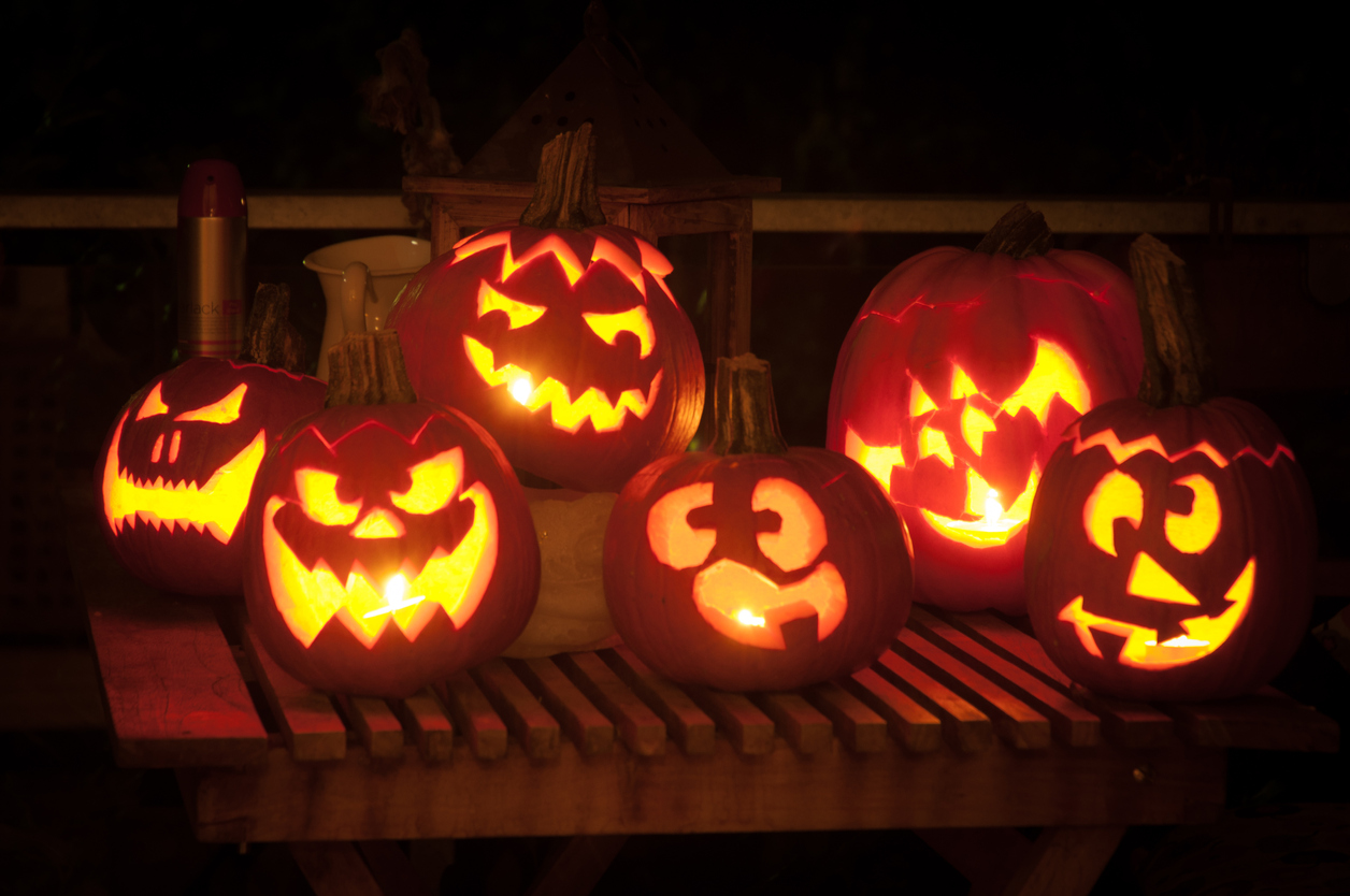 Pumpkins cut into Jack O' Lanterns with candles inside