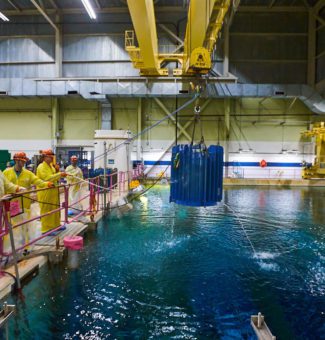 Workers at Pickering Nuclear GS crane a flask loaded with Cobalt-60 out of the irradiated fuel bay.