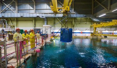 Workers at Pickering Nuclear GS crane a flask loaded with Cobalt-60 out of the irradiated fuel bay.