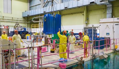 Workers prepare to clean a shipping flask loaded with Cobalt-60 bundles at Pickering Nuclear GS.