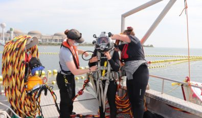 Diver Drew Burstahler gears up to head into the water to work on Pickering Nuclear's Fish Diversion System.