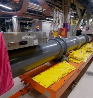 A 13,600-kilogram flask loaded with a pressure tube, a calandria tube, and four garter springs is prepared for transport.