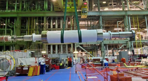 A turbine generator being lifted during refurbishment.
