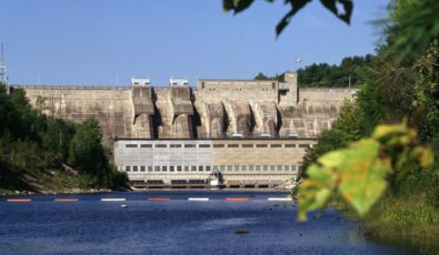 Safety booms in the water beside Stewartville Hydro Generating Station
