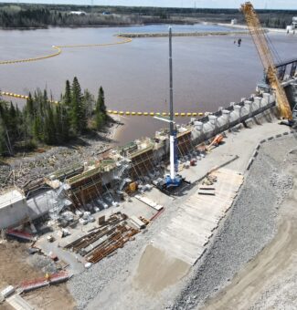 Exterior of Smoky Falls GS with construction activities underway