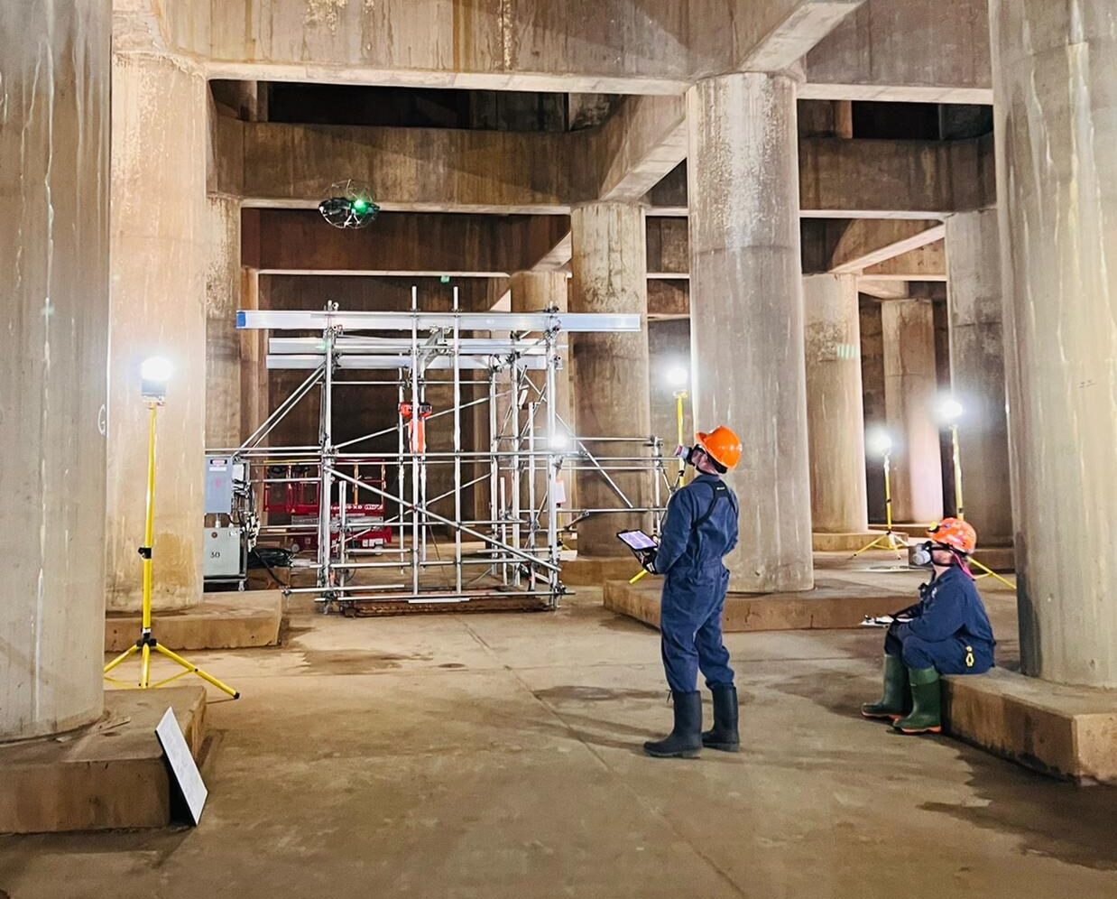 OPG employees control a drone to inspect Pickering Nuclear's vacuum building.