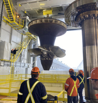 The massive turbine runner is pulled up from R.H. Saunders GS's Unit 9, which is undergoing an overhaul.