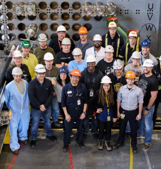 Employees and contractors pose in the reactor mock-up to celebrate the recent Unit 3 milestone.