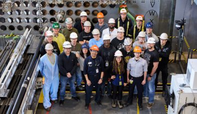 Employees and contractors pose in the reactor mock-up to celebrate the recent Unit 3 milestone.