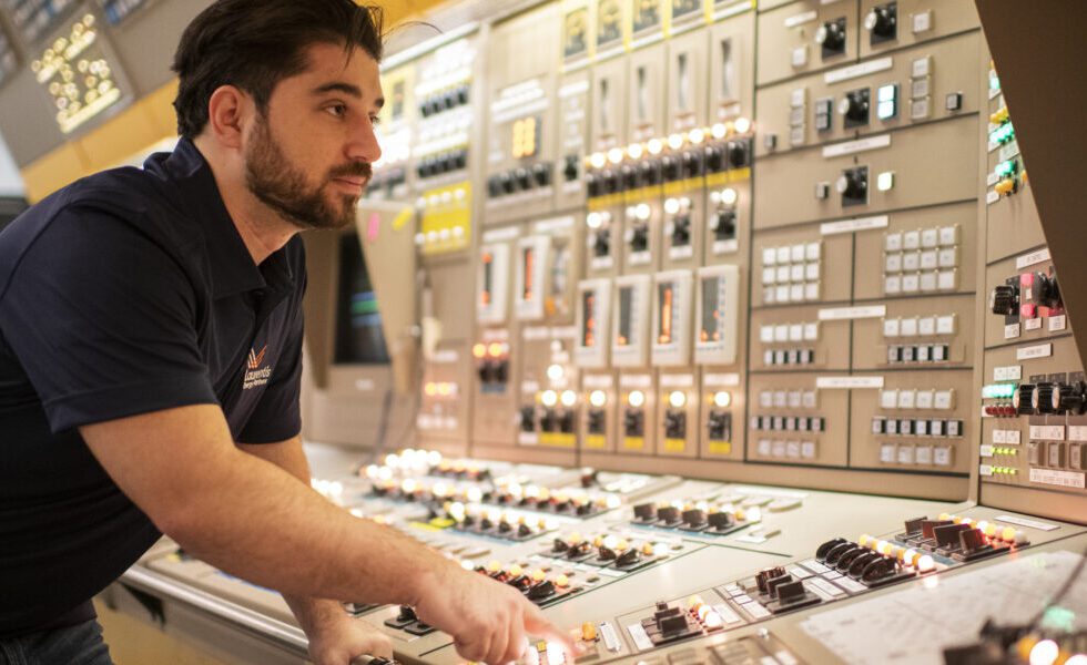 A Laurentis Energy employee in a nuclear control room.
