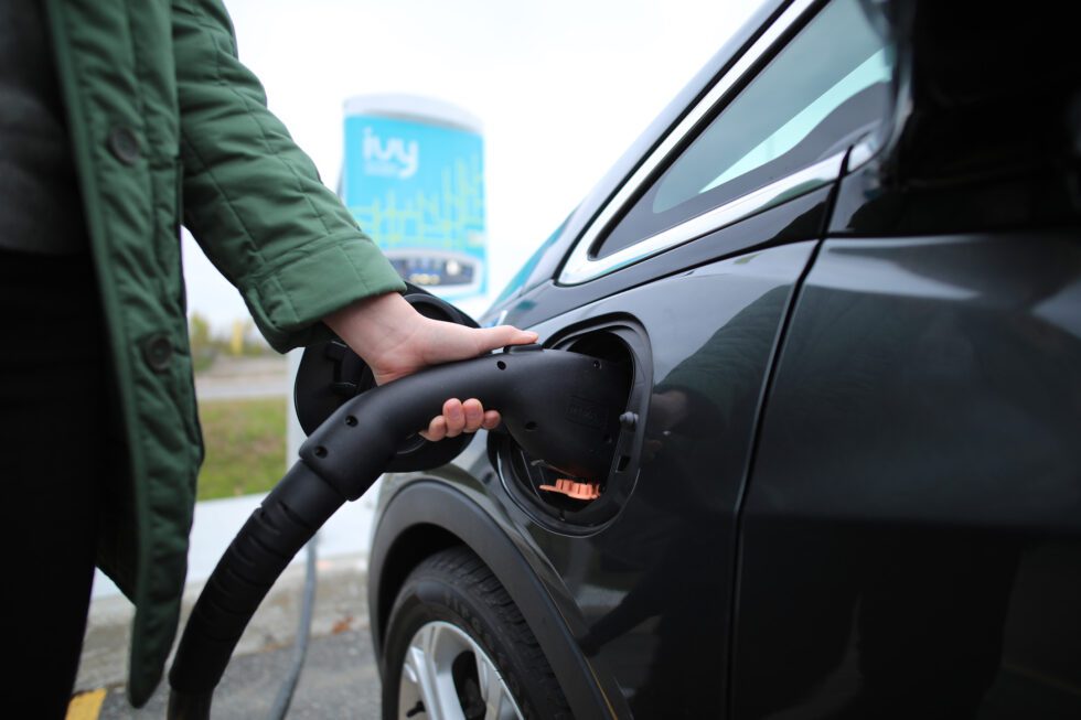 Plugging in an electric car at an Ivy Charging Network charging station.