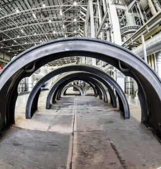 A row of end covers from Darlington Unit 2 low pressure turbines lined up on the turbine floor.