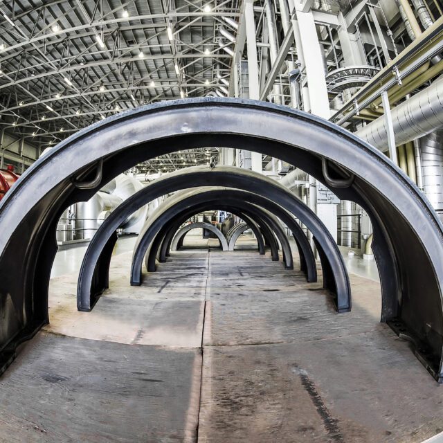 A row of end covers from Darlington Unit 2 low pressure turbines lined up on the turbine floor.