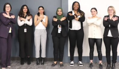 Erum Hasan, centre, and others pictured in the #EmbraceEquity pose during International Women’s Day at OPG’s Pickering Nuclear Information Centre. Erum co-emceed the event.