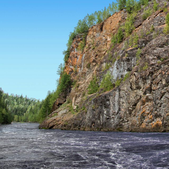 A steep cliff across the river from Abitibi Canyon Generating Station.