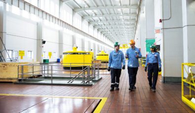 OPG workers walk through the turbine hall at the Sir Adam Beck generating complex.