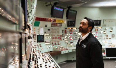 An authorized nuclear operator examines control room panels at the Pickering Nuclear Generating Station.