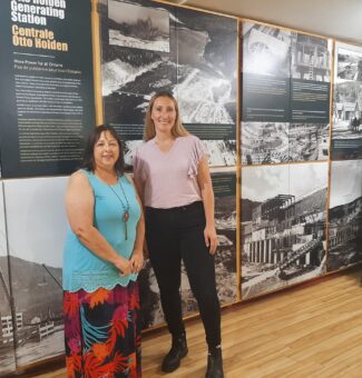 Judy Toupin, Curator of the Mattawa Museum, left, with Emily Salvalaggio, Senior Manager of OPG's Otto Holden and Des Joachims Generating Stations. Behind them is the museum's new exhibit on the Otto Holden Generating Station.