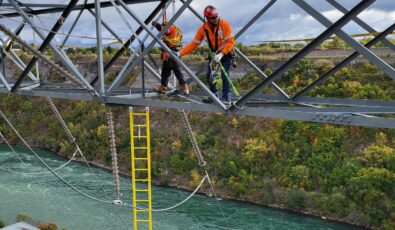 Workers use safety harnesses as they work on a gantry tower high above OPG's Sir Adam Beck II.