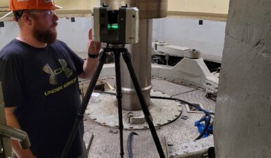 An OPG employee captures data points at a hydroelectric facility.