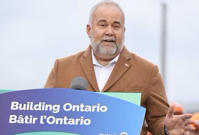 Ontario Minister of Energy, Todd Smith, speaks from a podium outside the Pickering Nuclear Generating Station.