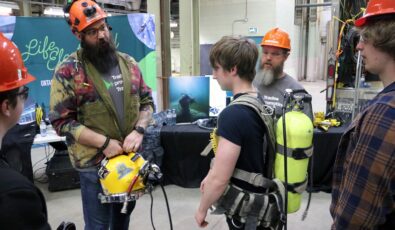 A student tries on diving gear at the Trades Promoting Trades event at OPG's Lennox GS.