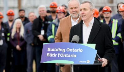 OPG's President and CEO, Ken Hartwick, speaks at an announcement on Pickering Nuclear's refurbishment. Ontario Energy Minister, Todd Smith, looks on in the background.