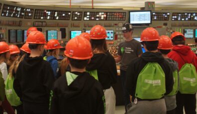 Students tour a control room at OPG's Lennox GS.